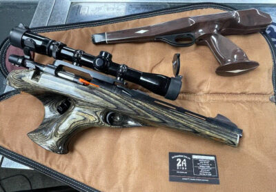 Remington, XP-100, Bolt Action Pistol, .221 Rem Fireball, Weaver scope mount, Burris 2.5x-7x scope, Original Brown, white, and black stock, aftermarket green lacquered wood stock, 11.75″ barrel, OEM leather case, fin front iron sight.